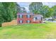 Charming brick home with black shutters, green lawn, and wooden fence at 3219 Spring Valley Dr, Gastonia, NC 28052