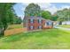 Charming brick home with black shutters, green lawn, and wooden fence at 3219 Spring Valley Dr, Gastonia, NC 28052