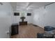 Cozy living room has two TVs, wood plank flooring, and comfy seating at 3219 Spring Valley Dr, Gastonia, NC 28052