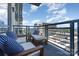 Relaxing condo balcony view featuring white furnishings with blue striped pillows and city views at 333 W Trade St # 805, Charlotte, NC 28202
