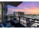 Relaxing condo balcony featuring comfortable lounge chairs and breathtaking city views at sunset at 333 W Trade St # 805, Charlotte, NC 28202