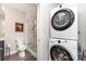 Compact bathroom featuring a walk-in shower and stackable washer and dryer at 333 W Trade St # 805, Charlotte, NC 28202