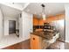 Well-lit kitchen featuring an island with bar stools, stainless steel appliances, and hardwood flooring at 333 W Trade St # 805, Charlotte, NC 28202