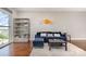Cozy living room featuring hardwood floors, a bookshelf, and a large picture window at 333 W Trade St # 805, Charlotte, NC 28202