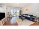 Sunlit living room with modern decor, hardwood floors, and large windows overlooking the city at 333 W Trade St # 805, Charlotte, NC 28202