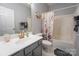 Well-maintained bathroom featuring a floral shower curtain, vanity, and modern fixtures at 3412 Summerfield Ridge Ln, Matthews, NC 28105