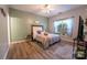 Cozy bedroom boasts a decorative headboard, ceiling fan, and plush rug at 3412 Summerfield Ridge Ln, Matthews, NC 28105