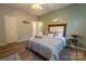 Comfortable bedroom boasts a decorative headboard, ample closet space, and stylish decor at 3412 Summerfield Ridge Ln, Matthews, NC 28105