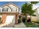Charming townhouse featuring a one-car garage, red brick accents, and a well-manicured lawn at 3412 Summerfield Ridge Ln, Matthews, NC 28105