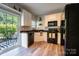 Bright kitchen with white cabinetry, stainless steel appliances, and sliding door to the patio at 3412 Summerfield Ridge Ln, Matthews, NC 28105