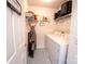 Functional laundry room with washer, dryer, and organized shelving at 3412 Summerfield Ridge Ln, Matthews, NC 28105