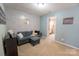 Living room featuring a comfortable gray sofa with modern accents at 3412 Summerfield Ridge Ln, Matthews, NC 28105