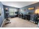Well-lit office featuring multiple monitors, desk space, and gym equipment for a versatile setup at 3412 Summerfield Ridge Ln, Matthews, NC 28105