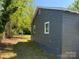A side view of a single-story home surrounded by lush greenery at 358 Orr Dr, Rock Hill, SC 29730