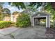 A home with a detached garage that has an open entrance with a paved driveway and mature landscaping at 3612 The Plz, Charlotte, NC 28205