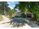 Traditional-style home with detached garage and long driveway, with mature trees at 3612 The Plz, Charlotte, NC 28205