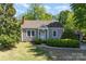 Charming one-story home features a manicured lawn, mature trees, and a welcoming front entrance at 3612 The Plz, Charlotte, NC 28205