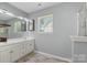 Bathroom featuring a double vanity with modern fixtures, complemented by wood-look tile flooring at 3744 Leela Palace Way, Fort Mill, SC 29708