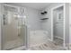 Bathroom with a glass-enclosed shower, a soaking tub, and a doorway at 3744 Leela Palace Way, Fort Mill, SC 29708