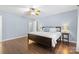 Bedroom with wood floors, ceiling fan, and a light blue wall at 3744 Leela Palace Way, Fort Mill, SC 29708
