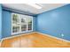 Bedroom featuring bamboo flooring, blue painted walls, and a bright window at 3744 Leela Palace Way, Fort Mill, SC 29708