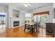 Dining room with hardwood floors, fireplace, and view to backyard at 3744 Leela Palace Way, Fort Mill, SC 29708