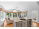 Light-filled kitchen features a large island with seating, granite countertops and stainless appliances at 3744 Leela Palace Way, Fort Mill, SC 29708