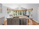 Bright kitchen boasts granite countertops, an island with sink, and large windows at 3744 Leela Palace Way, Fort Mill, SC 29708