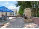 Charming patio features a stone fireplace, quaint swing and a dining set under a blue gazebo at 3744 Leela Palace Way, Fort Mill, SC 29708