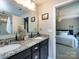 Bathroom featuring a dual sink vanity with granite countertops that opens to the bedroom at 4012 Martele Dr, Mint Hill, NC 28227