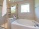 Relaxing bathroom with a soaking tub, separate glass shower, and neutral tile surround at 4012 Martele Dr, Mint Hill, NC 28227