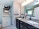 Well-lit bathroom featuring a dual sink vanity with granite countertops and a large linen closet at 4012 Martele Dr, Mint Hill, NC 28227