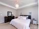 Bright bedroom featuring a tray ceiling, pendant lighting, a comfy bed, and a dark wood dresser at 4012 Martele Dr, Mint Hill, NC 28227