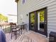 Outdoor deck featuring a glass table and chairs, access to the home, and backyard view at 4012 Martele Dr, Mint Hill, NC 28227