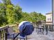 Relaxing outdoor deck featuring patio furniture and a covered grill overlooking a green backyard at 4012 Martele Dr, Mint Hill, NC 28227