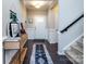 Well-lit entryway showcasing hardwood floors, a console table, wainscoting, and a staircase leading upstairs at 4012 Martele Dr, Mint Hill, NC 28227