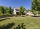 Expansive lawn with mature trees surrounding this two-story home, creating a serene outdoor space at 4012 Martele Dr, Mint Hill, NC 28227