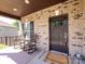 Cozy front porch featuring classic rocking chairs and brick accents, creating a welcoming entrance at 4012 Martele Dr, Mint Hill, NC 28227