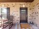Inviting front porch featuring a brick wall, classic rocking chairs, and a charming front door at 4012 Martele Dr, Mint Hill, NC 28227
