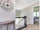 Upstairs hallway featuring a staircase, carpeted floors, and decorative wall decor with a view into the bedrooms at 4012 Martele Dr, Mint Hill, NC 28227
