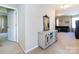 Open hallway featuring neutral walls and carpet, a decorative cabinet, and access to a bedroom and den at 4012 Martele Dr, Mint Hill, NC 28227