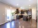 Open-concept kitchen with dark cabinetry, a center island, stainless steel appliances, and hardwood floors at 4012 Martele Dr, Mint Hill, NC 28227