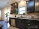 The kitchen features dark cabinetry, granite counters, stainless steel appliances, and a decorative tile backsplash at 4012 Martele Dr, Mint Hill, NC 28227