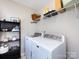 Functional laundry room featuring a modern washer and dryer, storage shelf and space at 4012 Martele Dr, Mint Hill, NC 28227
