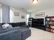 Cozy living room featuring a plush gray sectional sofa, built-in bookshelves, and a large entertainment center at 4012 Martele Dr, Mint Hill, NC 28227