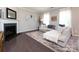 Inviting living room featuring a fireplace, neutral decor, a sectional sofa, and hardwood floors at 4012 Martele Dr, Mint Hill, NC 28227