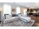 Open living room with a sectional sofa, hardwood floors, and a view into the kitchen at 4012 Martele Dr, Mint Hill, NC 28227