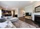Spacious living room with hardwood floors, a fireplace, and a view into the kitchen at 4012 Martele Dr, Mint Hill, NC 28227