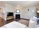 Bright living room with a fireplace, hardwood floors, neutral walls, and a comfortable white sofa at 4012 Martele Dr, Mint Hill, NC 28227