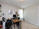 Office space with a desk, office chair, wall art, and a bright window with curtain at 4012 Martele Dr, Mint Hill, NC 28227